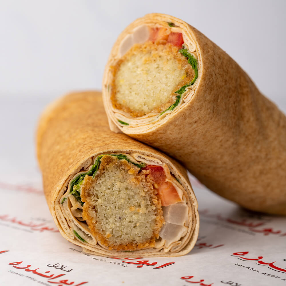 Experience the signature falafel sandwich from Abou Andre! This sandwich features protein-packed falafel balls bursting with fiber, made with fresh ingredients according to our exclusive recipe.