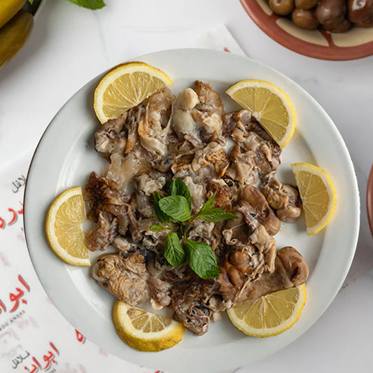 "Traditional Lebanese Maqadem plate at Falafel Abou Andre, slow-cooked sheep trotters served with fresh lemon wedges and mint."