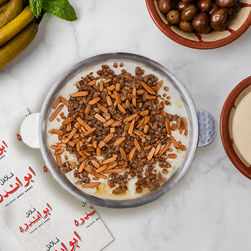 "Freshly prepared Fattet qawarma with traditional Lebanese lamb qawarma, yogurt, and toasted almonds."